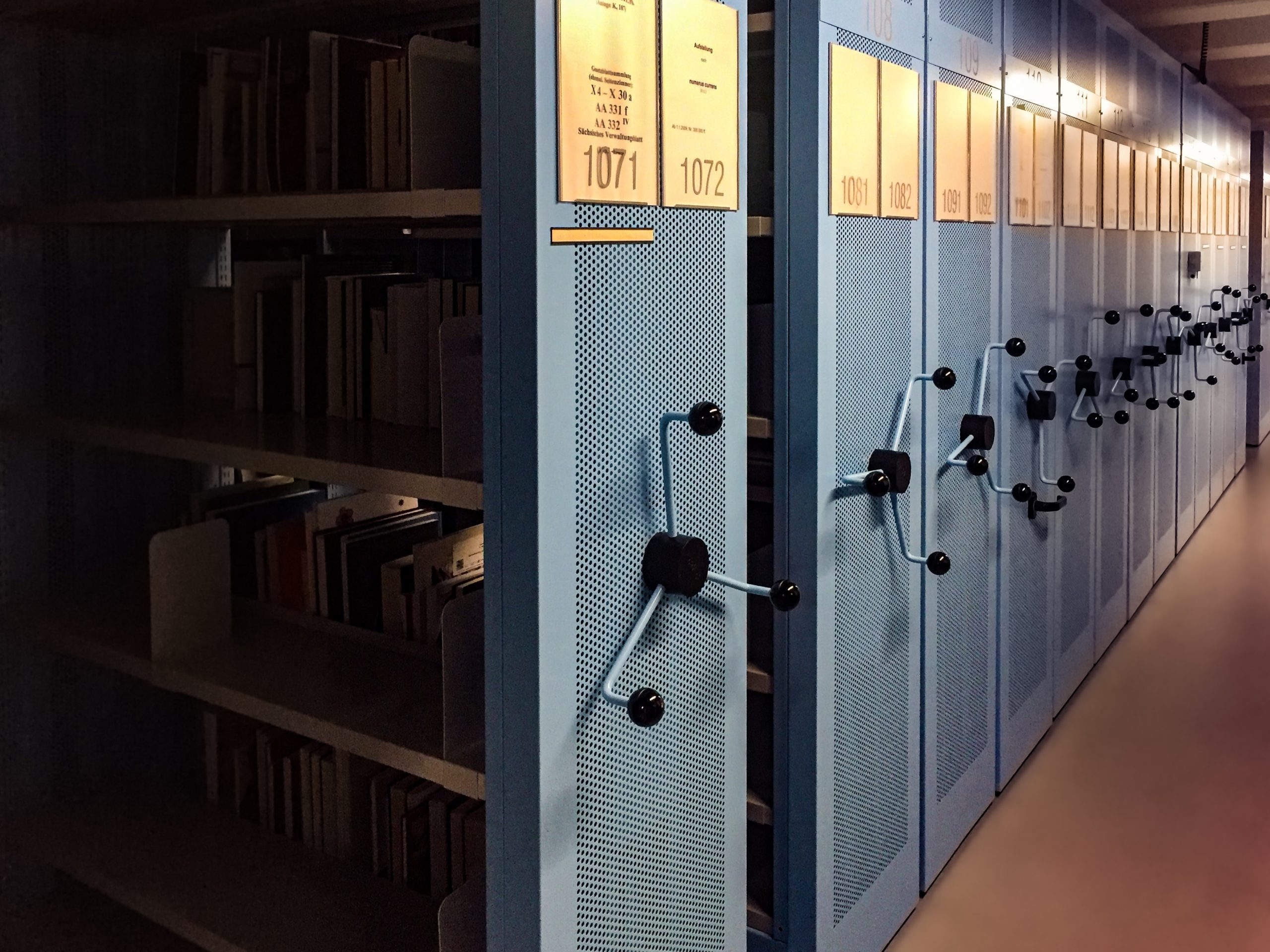 Metal archive shelves with turnstyle handles